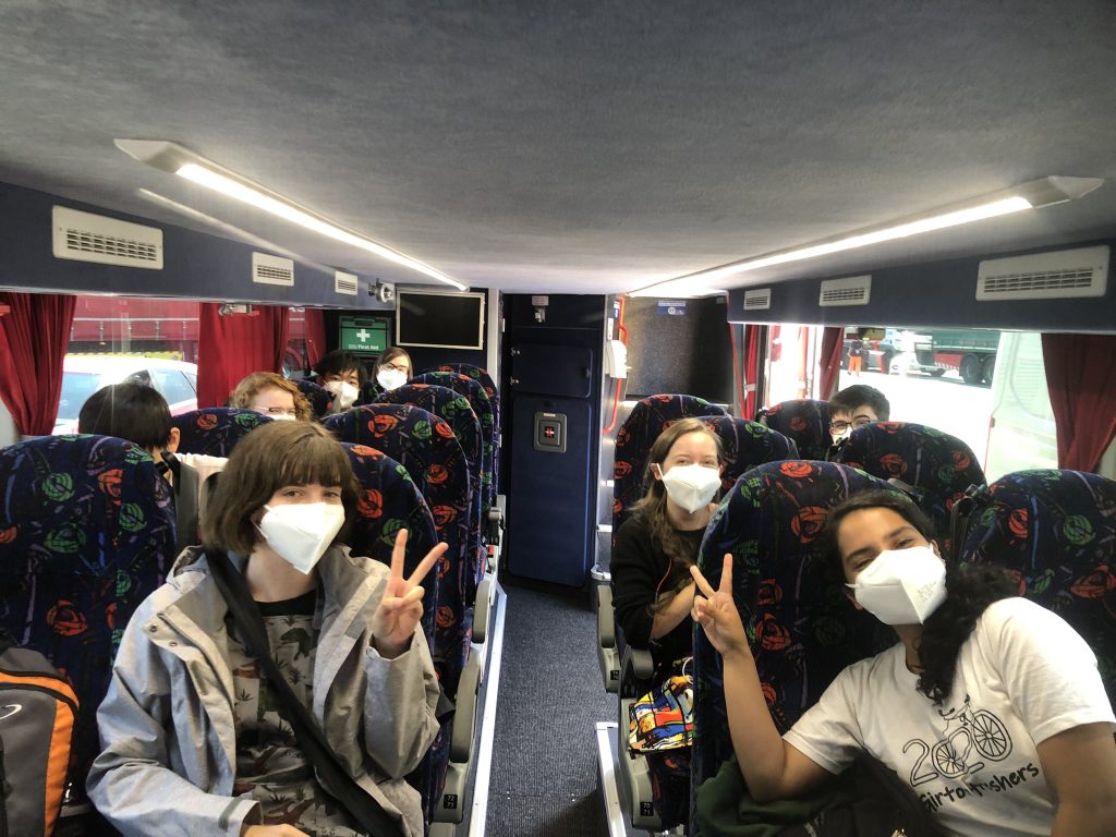 Students wear masks on the bus journey